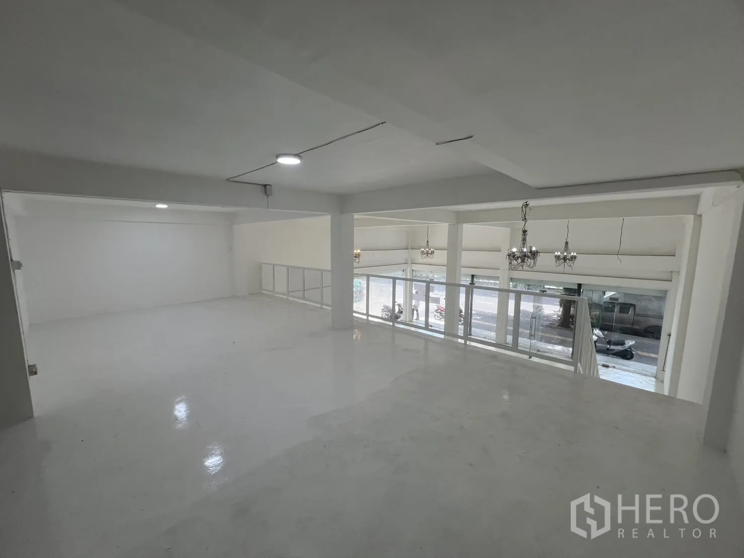 Retail Space for rent in Khlong Toei, Bangkok - View across the mezzanine toward the street, showing chandeliers and open space.