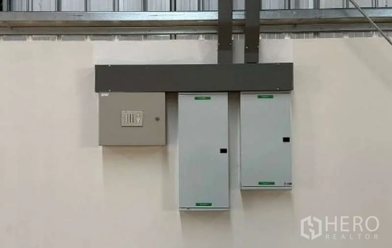 Warehouse for rent in Mueang Rayong, Rayong - Close-up of installed electrical control panels and conduit inside the warehouse.