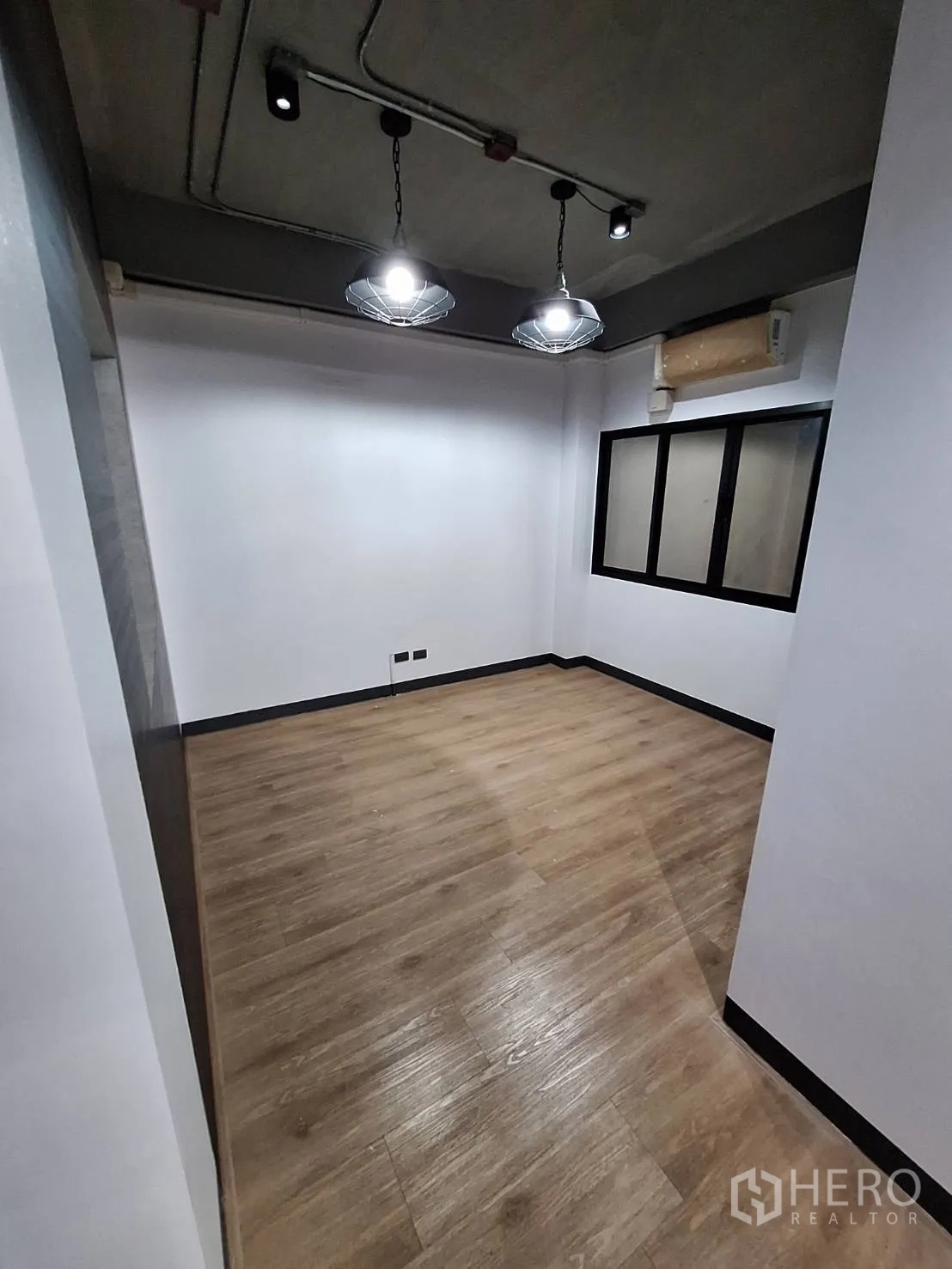 Office Space for rent - Reception area with built-in display shelving, blue accent wall and track lights.