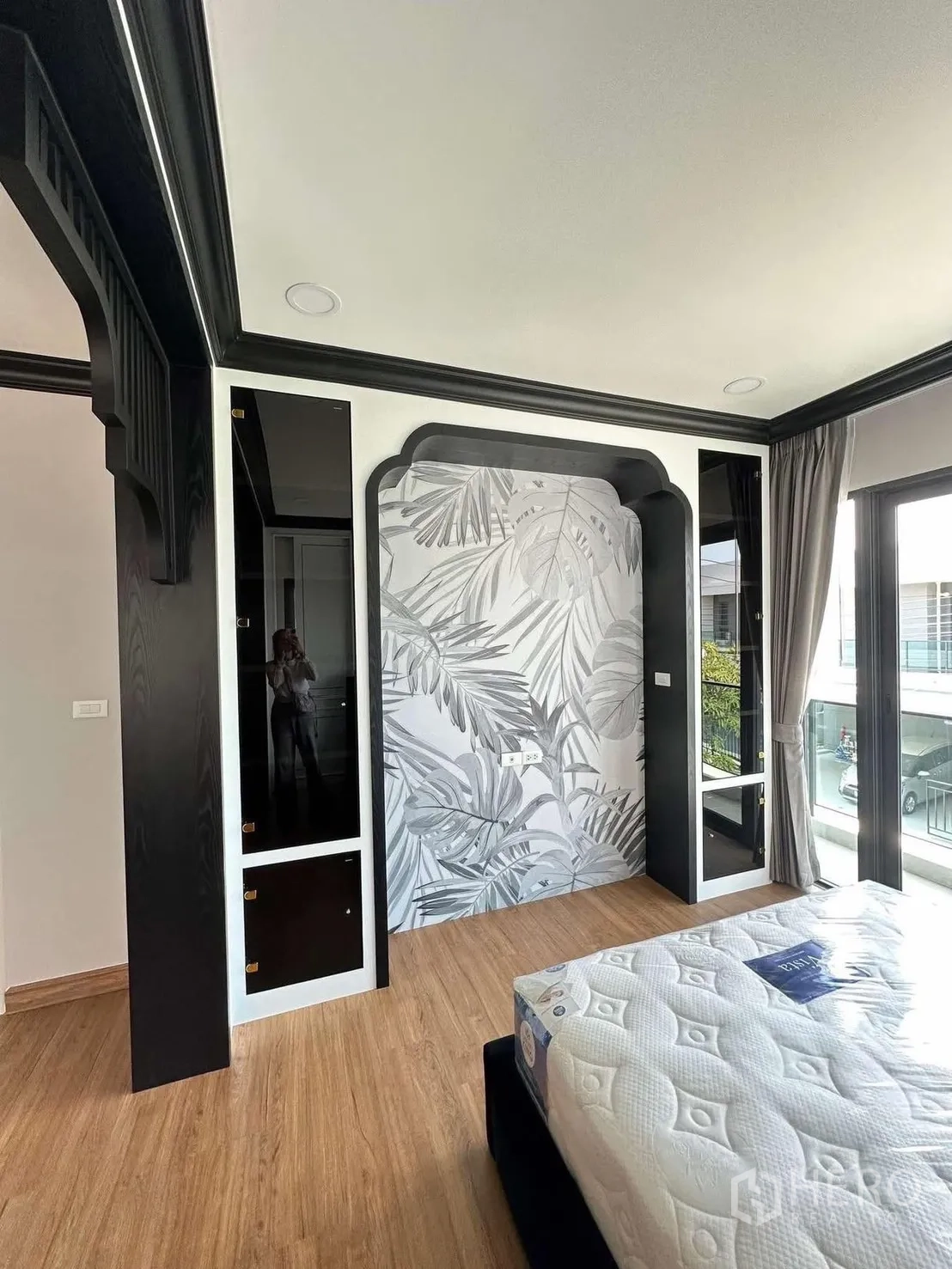 Detached House for rent in Bang Phli, Samut Prakan - Bedroom corner with patterned headboard wall, wood floors, and full-height windows.