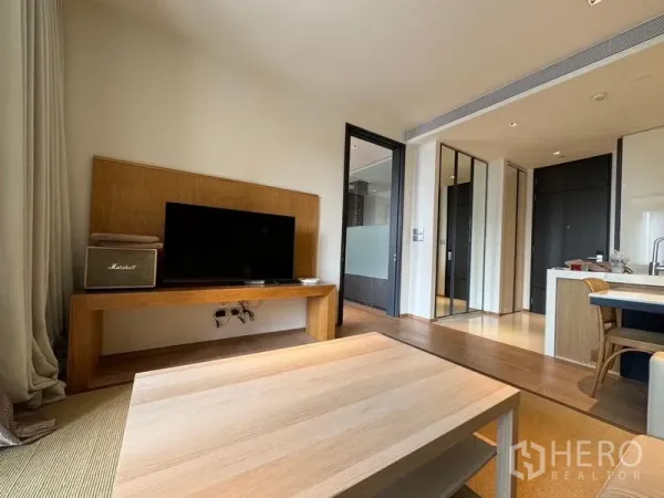 Condominium for rent - Living area with TV stand and coffee table, opening to the kitchen with island and entry hall.