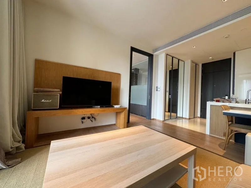 Condominium for rent - Living area with TV stand and coffee table, opening to the kitchen with island and entry hall.