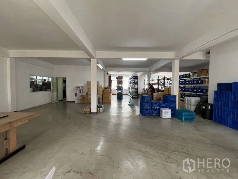 Shophouse for rent or sale in Khlong Toei, Bangkok - Deep storage area with concrete flooring, racks and packing space.