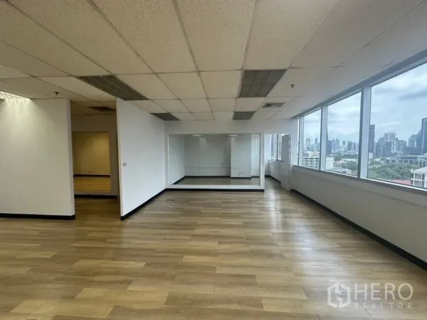 Office Space for rent in Phra Khanong, Bangkok - Spacious workspace with city skyline views through long windows and an internal glass room.