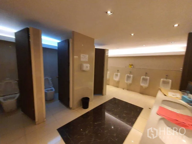 Office Space for rent in Watthana, Bangkok - Men’s restroom with stalls, urinals and vanity inside a Bangkok office building.