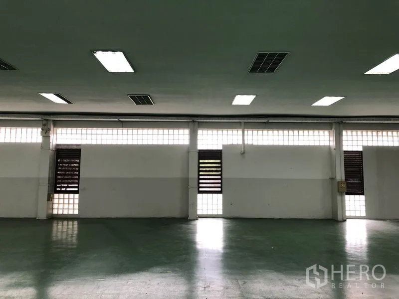 Factory for rent in Lat Krabang, Bangkok - Interior wall detail showing glass-block windows and ventilation panels.