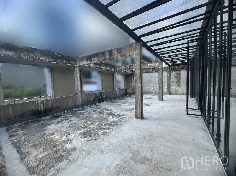 Retail Space for rent in Watthana, Bangkok - Expansive outdoor terrace with concrete columns and partial polycarbonate roof beside full-height glazing.