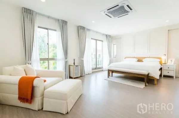 Detached House for rent - Spacious master bedroom with king bed, sofa lounge, large windows, balcony door, and cassette air conditioning.