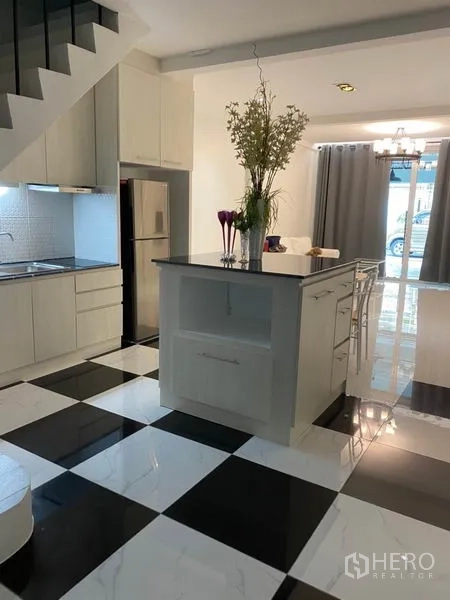 Townhouse for rent or sale in Khlong Toei, Bangkok - Kitchen with island, stainless fridge and curtains facing the front