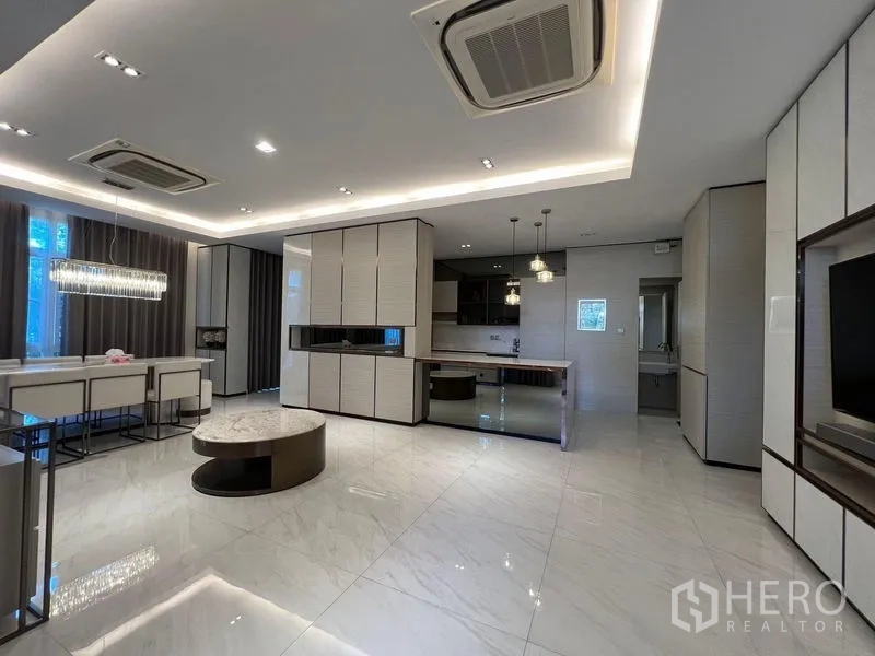Detached House for sale - Open-plan living and dining space with marble-look floors, recessed lighting and built-in cabinetry.