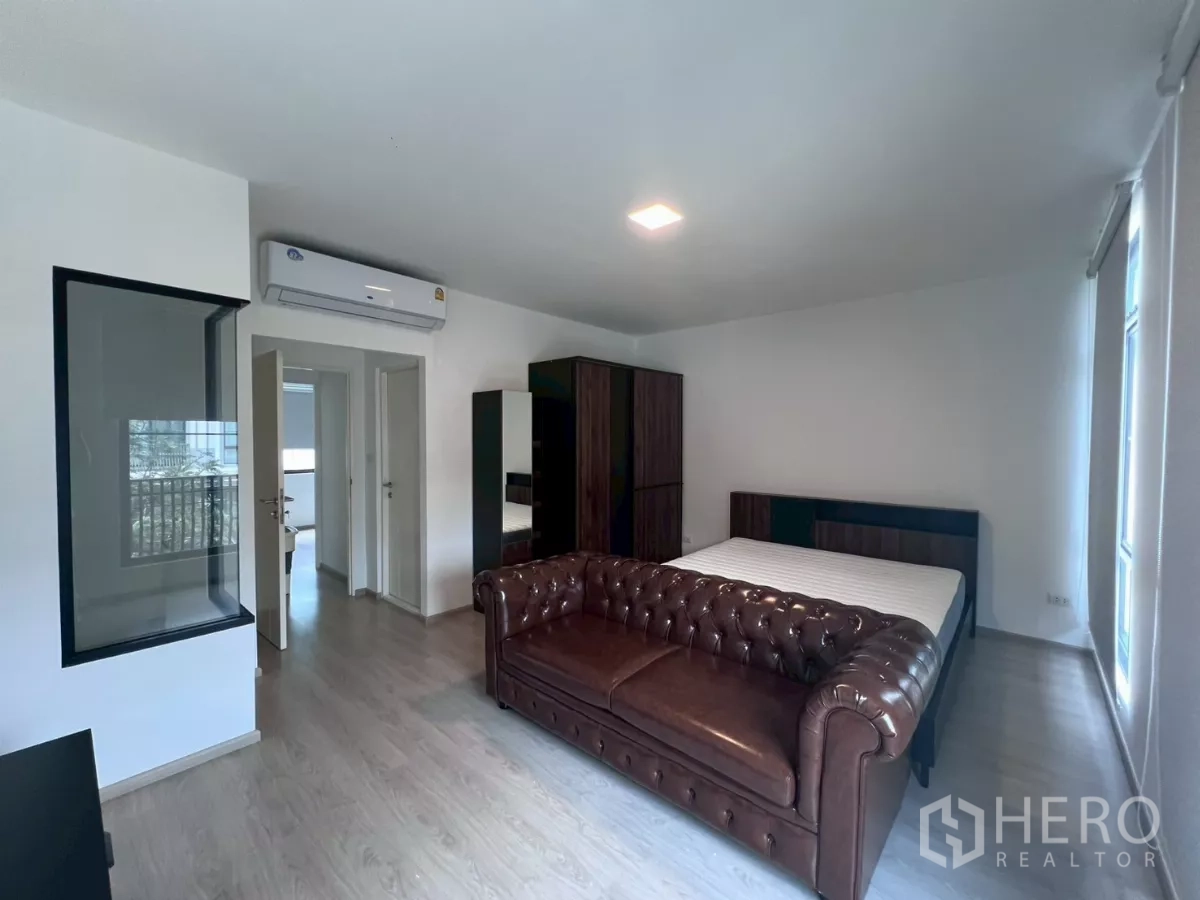 Townhouse for rent in Bang Phli, Samut Prakan - Master bedroom with air conditioner and doors leading to other rooms.