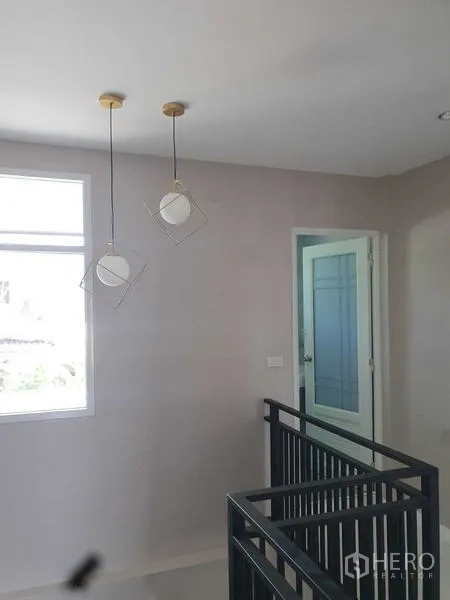 Home Office for rent in Suan Luang, Bangkok - Upper landing with modern pendant lights and black metal railing.