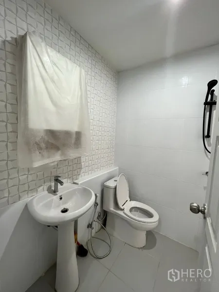 Home Office for rent in Watthana, Bangkok - Second bathroom with white tiles, pedestal sink, toilet and shower set.