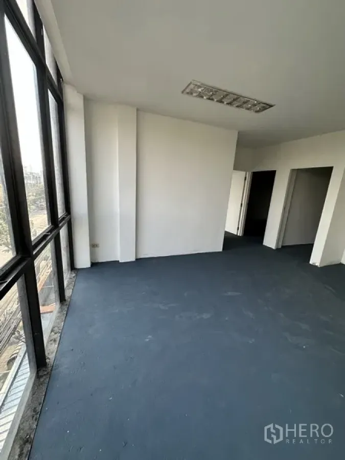 Shophouse for rent in Bang Na, Bangkok - Corner office area with panoramic windows and urban views.