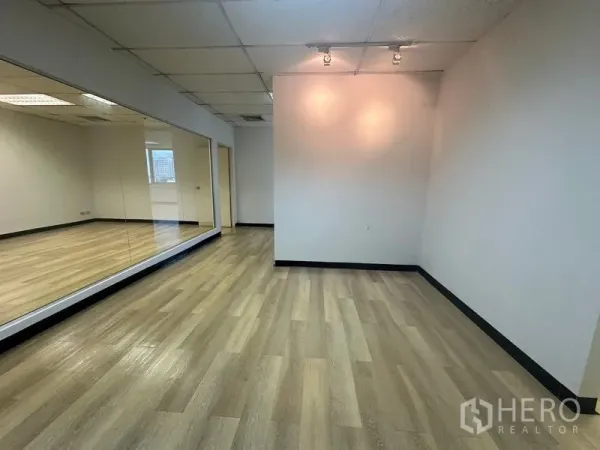Office Space for rent in Phra Khanong, Bangkok - Private office area with wood floors, spotlight wall and a full‑length mirrored feature.