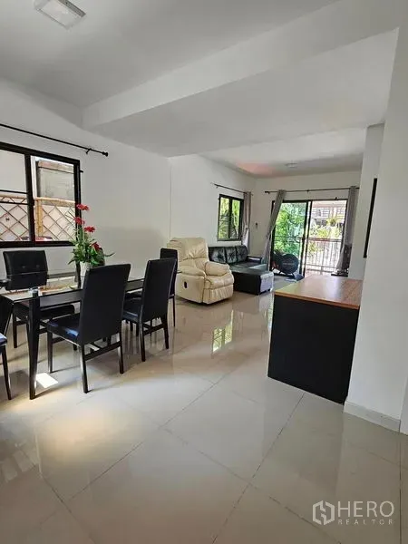 Townhouse for rent - Spacious ground floor layout showing dining zone, lounge and sliding doors to the front patio.