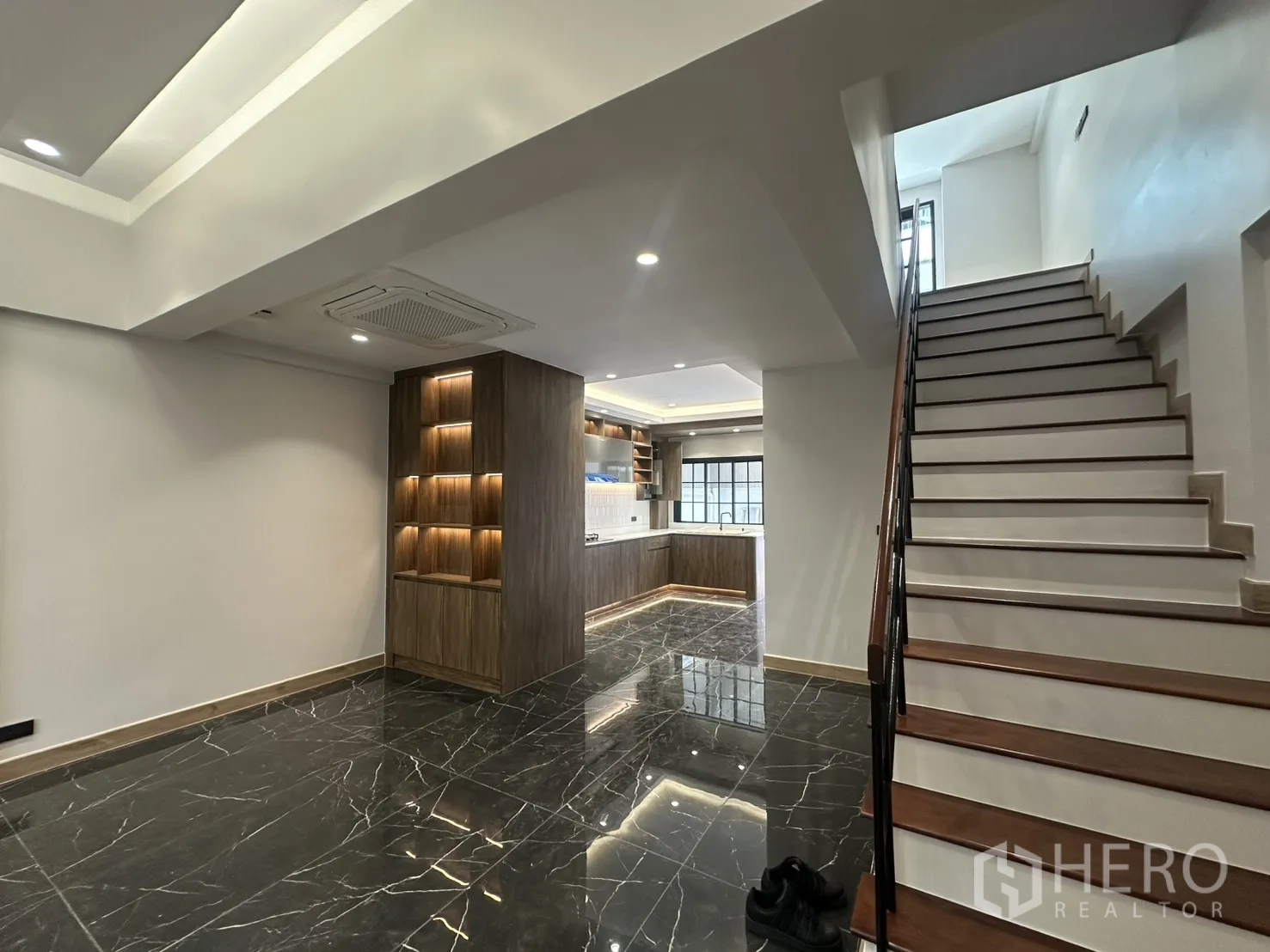 Home Office for rent in Watthana, Bangkok - Open-plan area with glossy black marble flooring and a staircase.