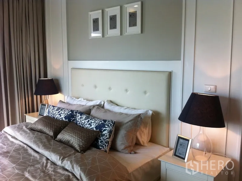 Condominium for rent in Bangkok - Cozy bedroom with padded headboard, twin bedside lamps, and layered bedding.