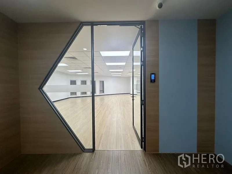 Office Space for rent in Chatuchak, Bangkok - Access-controlled glass door leading into a newly renovated office with modern finishes.