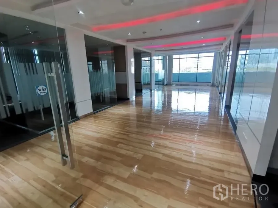 Office Space for rent in Bang Rak, Bangkok - Bright open-plan office with glossy wooden floor, glass partitions and large windows with city views.