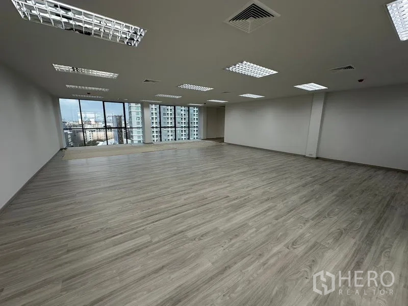 Office Space for rent - Spacious modern office with central air-conditioning vents and laminate flooring.