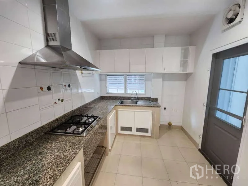 Detached House for rent in Sathon, Bangkok - Separate Thai kitchen with gas hob, hood, and granite countertops.