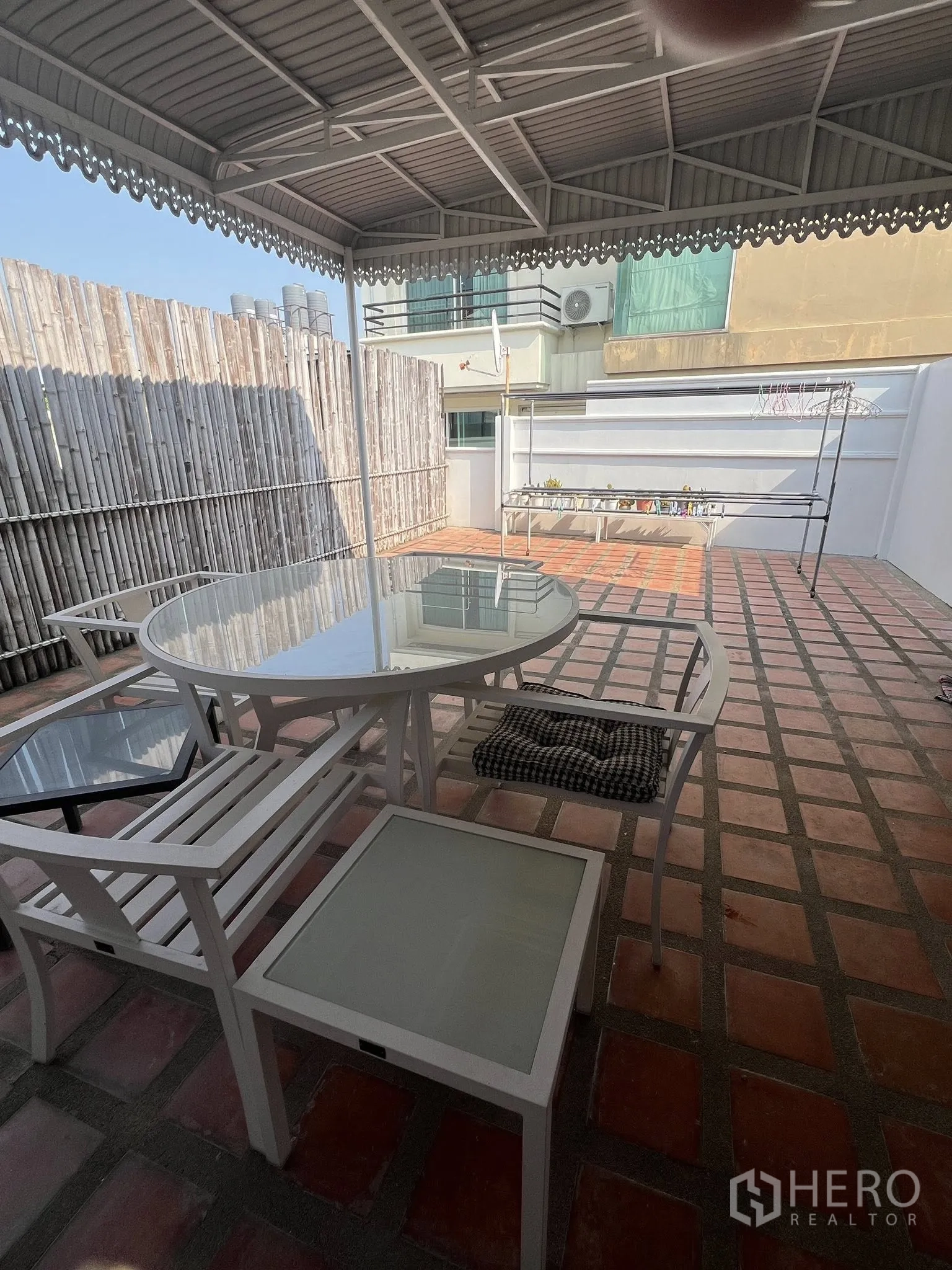 联排别墅 for rent or sale in Watthana, Bangkok - 屋顶露台设有顶棚与休闲桌椅，赤陶地砖铺设。