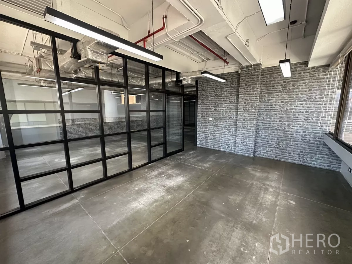 Office Space for rent - Private meeting room with brick feature wall and steel-framed glass.