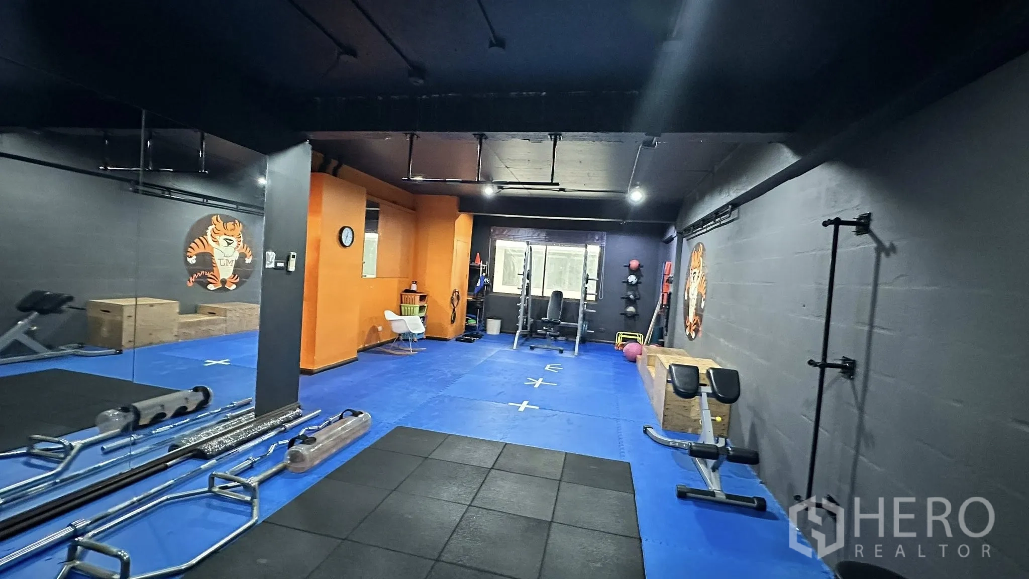 Office Space for rent in Huai Khwang, Bangkok - Spacious training room with mirrored wall, pull-up bars, and strength equipment.