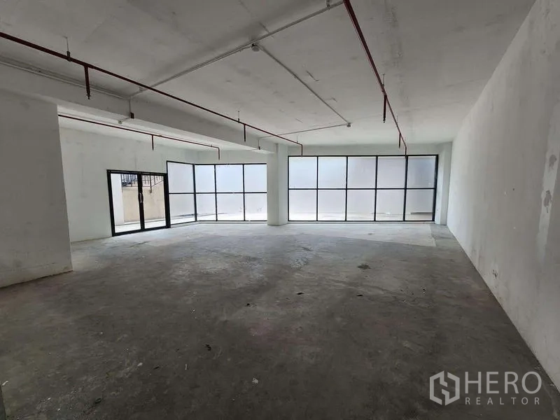 Retail Space for rent in Sathon, Bangkok - Open-plan shell retail interior with concrete floor, high ceiling, and full-height windows.