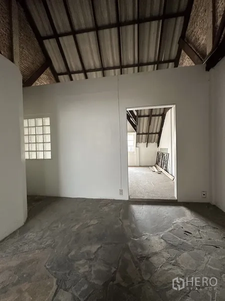 Retail Space for rent in Watthana, Bangkok - Loft landing with stone-like flooring and doorway to additional room.