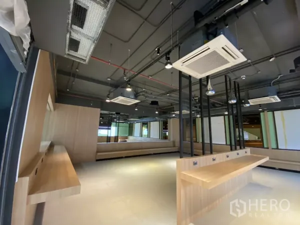 Retail Space for rent - Open-plan sales floor with wood counters, bench seating and cassette air-conditioners.