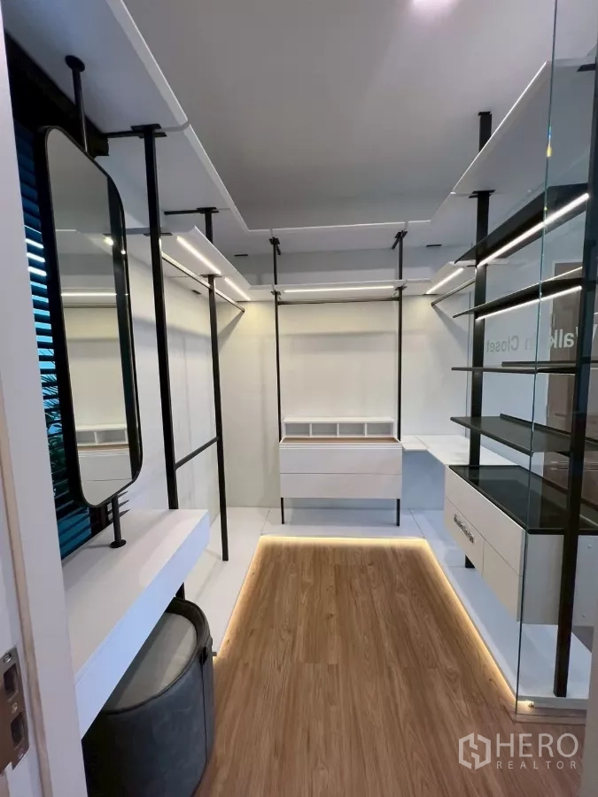 Detached House for rent in Samut Prakan - Walk-in closet with vanity, shelving, and LED strip lighting.
