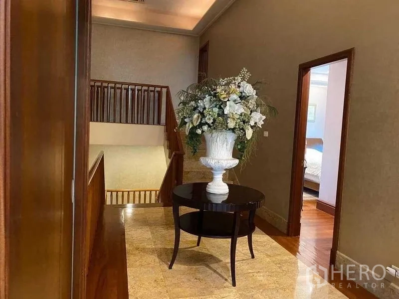Detached House for sale - Upper landing with round table, floral arrangement and staircase.