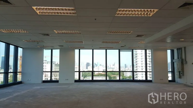Office Space for rent - Bright open‑plan office with floor‑to‑ceiling windows and skyline views in Sathon, Bangkok.