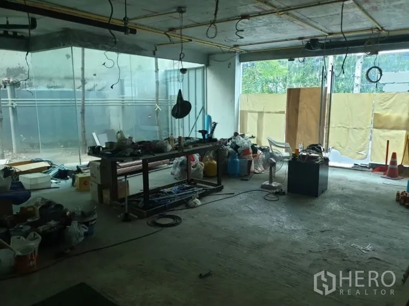 Retail Space for rent in Watthana, Bangkok - Ground-floor showroom under renovation with large glass frontage and tools.