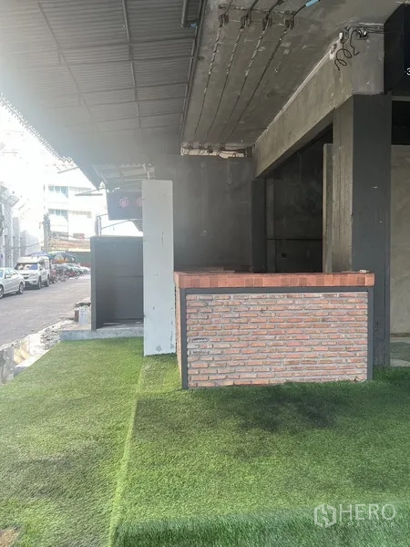 Retail Space for rent in Watthana, Bangkok - Close-up of a sliding door entrance leading to a concrete room under a covered roof.