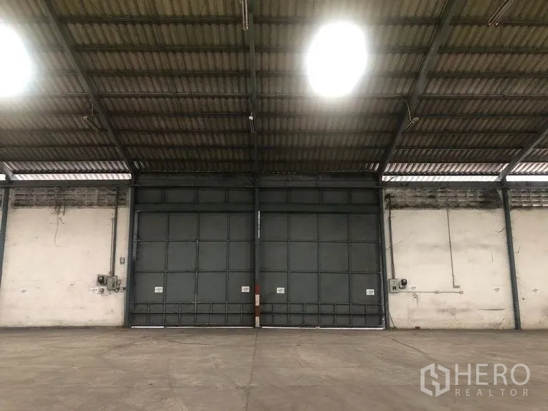 Warehouse for rent in Bang Pa-in, Phra Nakhon Si Ayutthaya - Close view of oversized steel industrial doors inside the warehouse.