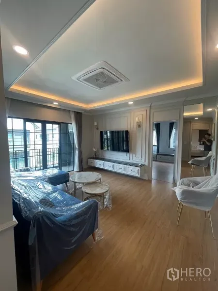 Detached House for rent in Bang Phli, Samut Prakan - Upstairs family lounge with wood floor, wall-mounted TV and balcony access.