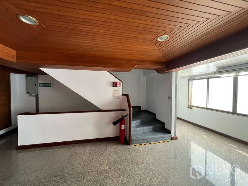 Office Space for rent - Stairwell and landing with wood ceiling and granite floors.
