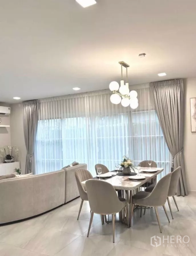 Detached House for rent in Bang Phli, Samut Prakan - Bright dining corner with six upholstered chairs and a globe pendant light.