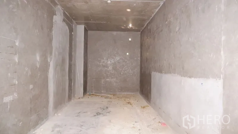 Retail Space for rent in Watthana, Bangkok - Unfitted 35 sqm retail interior with bare concrete walls, high ceiling and a rectangular layout ready for fit‑out.