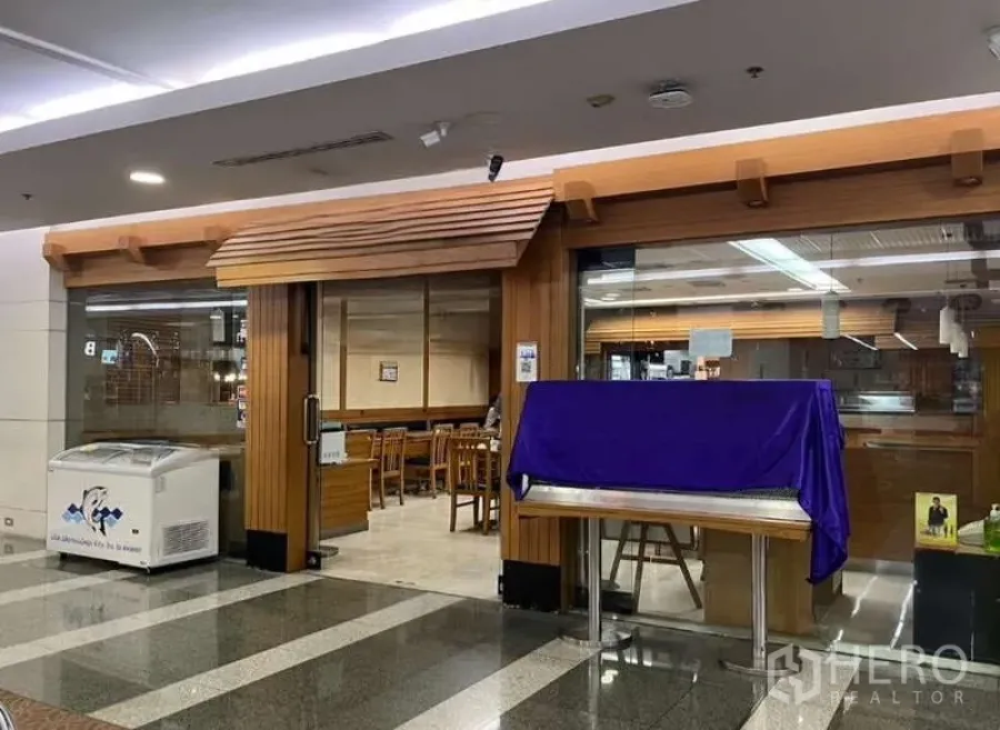 Retail Space for rent in Phaya Thai, Bangkok - Mall retail unit with wooden storefront, full-height glass frontage, and indoor seating, suitable for a café or eatery.