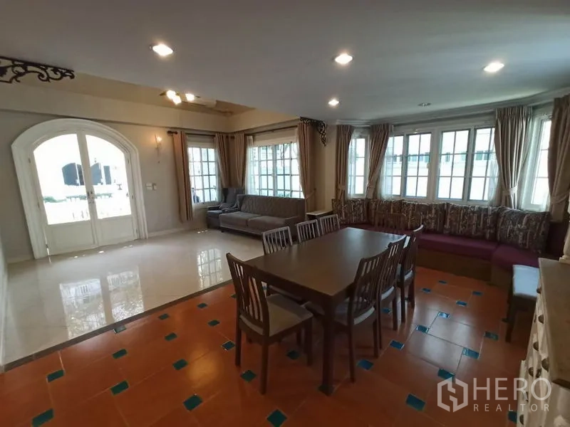 Detached House for rent in Mueang Samut Prakan, Samut Prakan - Bright living-dining area with arched double doors, curtains and ample natural light.