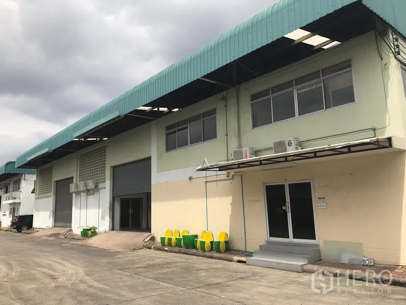 Warehouse for rent in Bang Phli, Samut Prakan - Street-side view of Bang Phli warehouse block with green roof canopies, offices and loading bays.