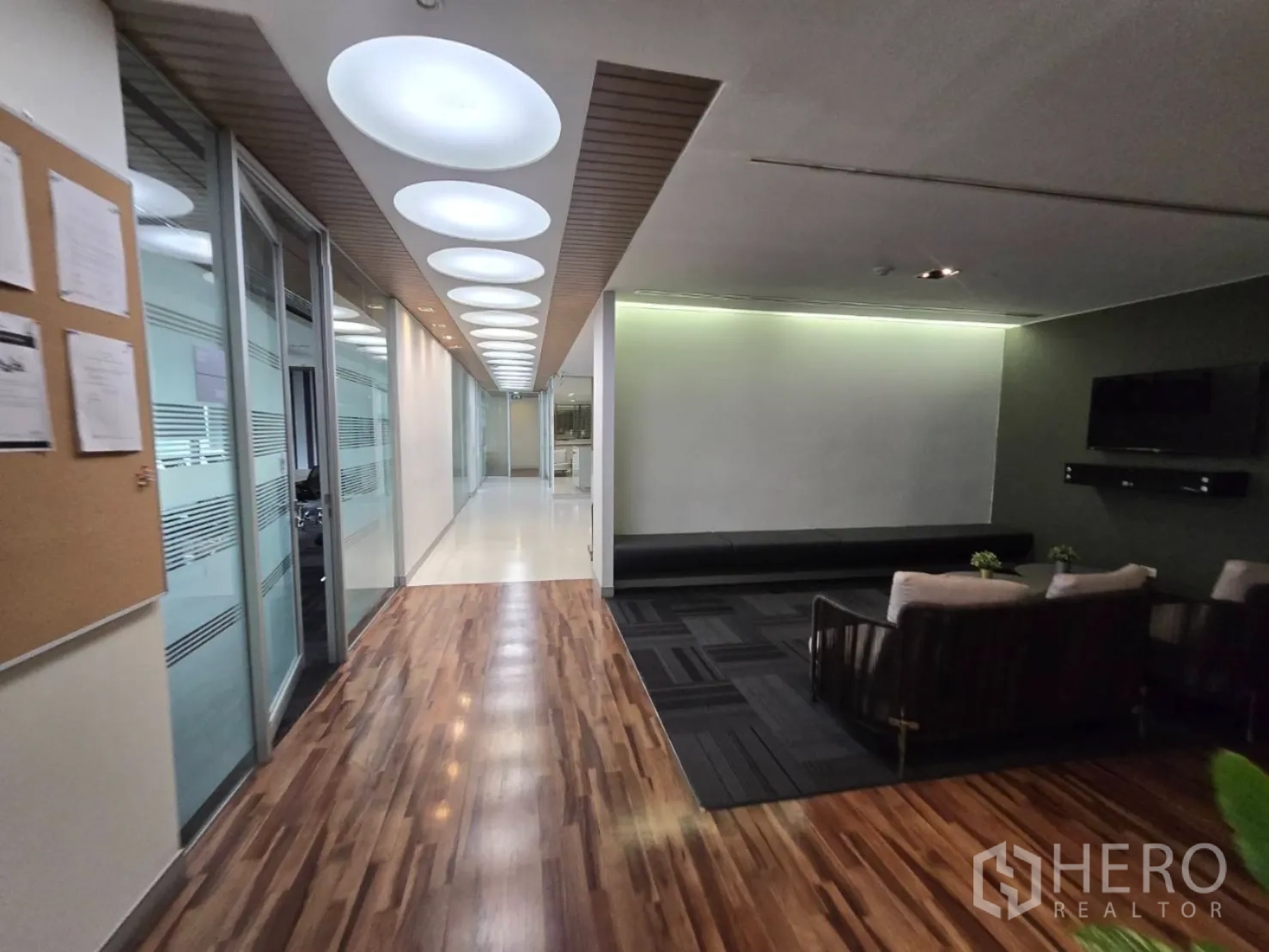 Office Space for rent in Watthana, Bangkok - Hallway with feature ceiling lights and adjacent lounge seating.