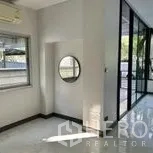 Home Office for rent in Wang Thonglang, Bangkok - Small nook with window and round mirror beside the main workspace.