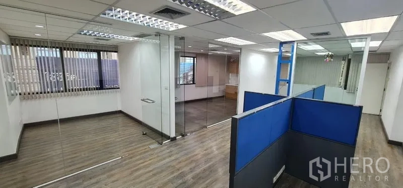 Office Space for rent in Watthana, Bangkok - Open office showing glass rooms, natural light, and shared workstations.