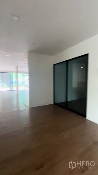 Retail Space for rent in Bang Na, Bangkok - Partitioned area with frosted glass sliding door and wood floors suitable for meeting room.