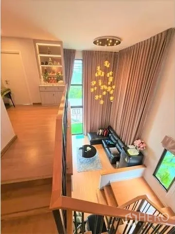 Detached House for sale in Suan Luang, Bangkok - Stairwell with wood steps, double‑height window, chandelier, and a cozy seating nook.